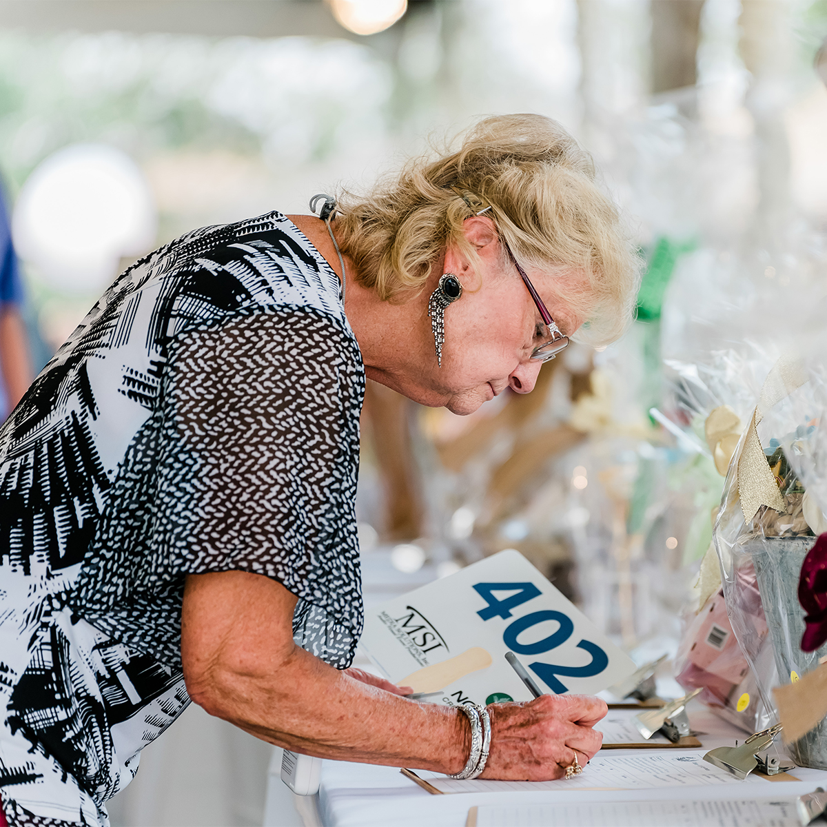 CASA Crab Feed Photos_Older Lady Signing Up for a Raffle
